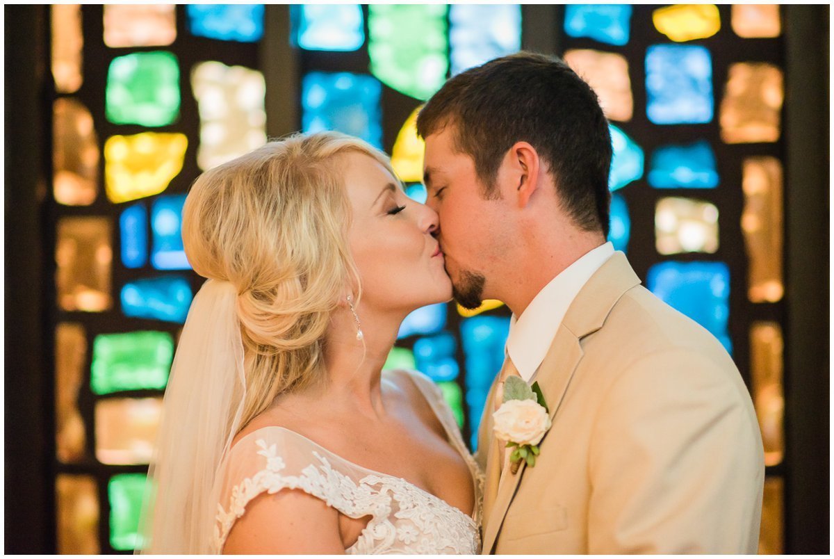 Bride and Groom with stained glass at Clear Lake United Methodist Church Wedding