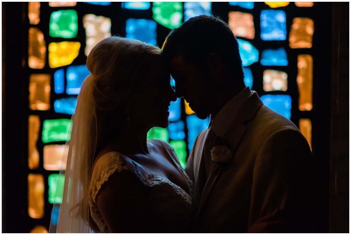 Bride and Groom with stained glass at Clear Lake United Methodist Church Wedding